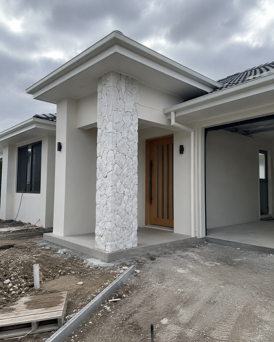 Modern house entrance with a white crazy stone feature column